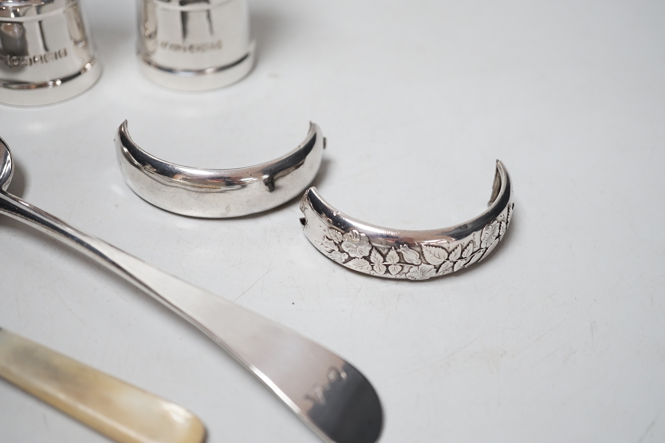 A modern pair silver mounted salt and pepper grinders, 10.6cm, a Georgian silver table spoon, A Victorian mother of pearl handled spoon and a damaged silver bangle.